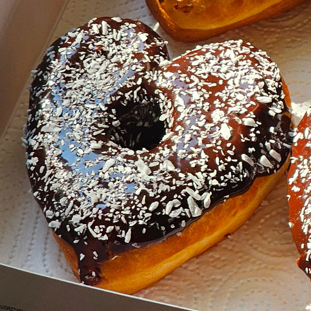 A box of chocolate coconut heart donuts