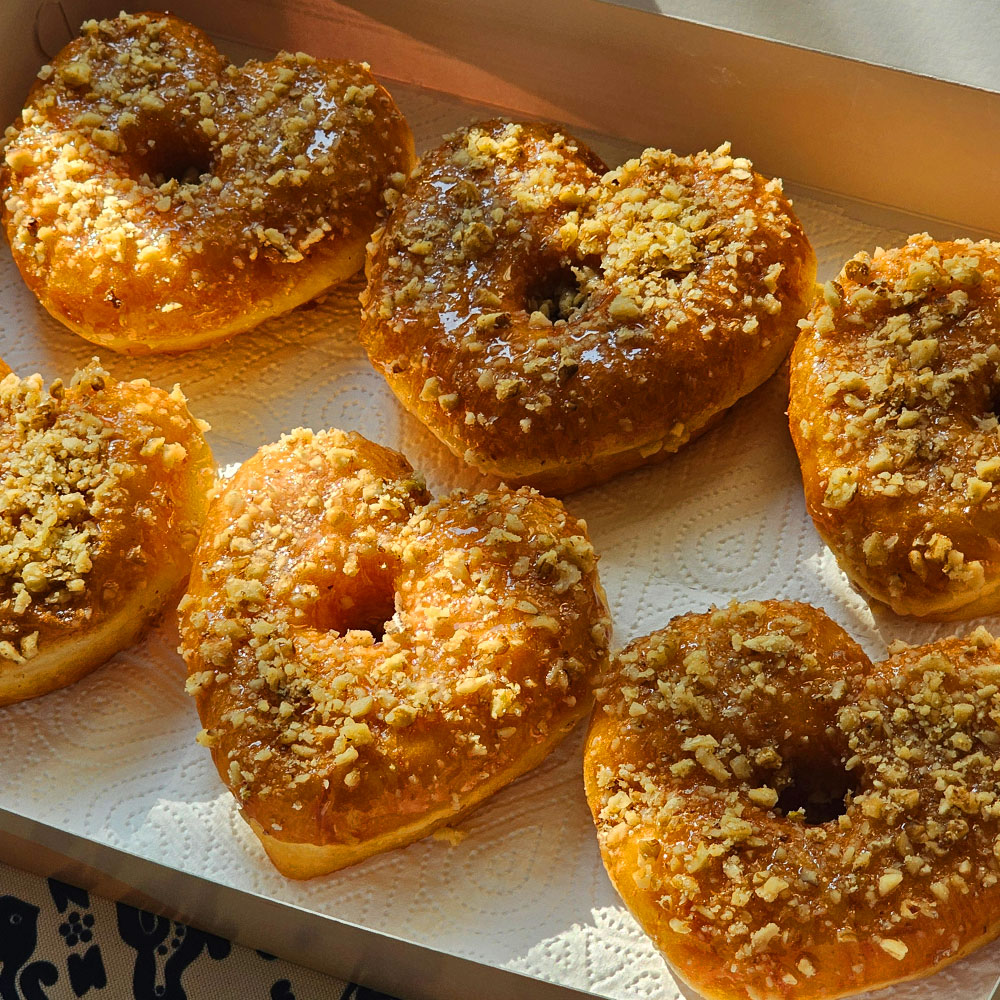 Honey walnut heart donuts in an open box