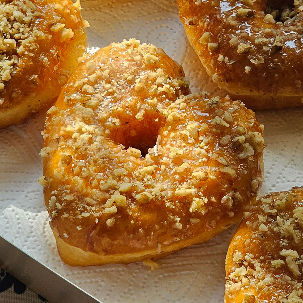 A honey walnut heart donut close up