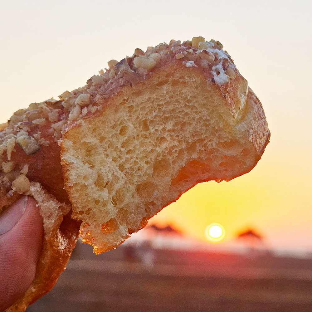 Honey walnut heart donut torn open at sunset