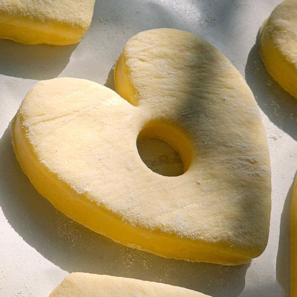 A risen pale heart of dough in morning light