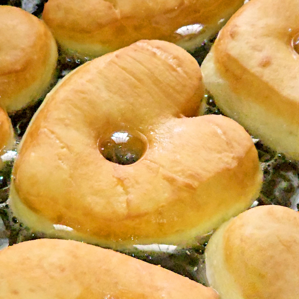 Heart donuts frying in hot oil