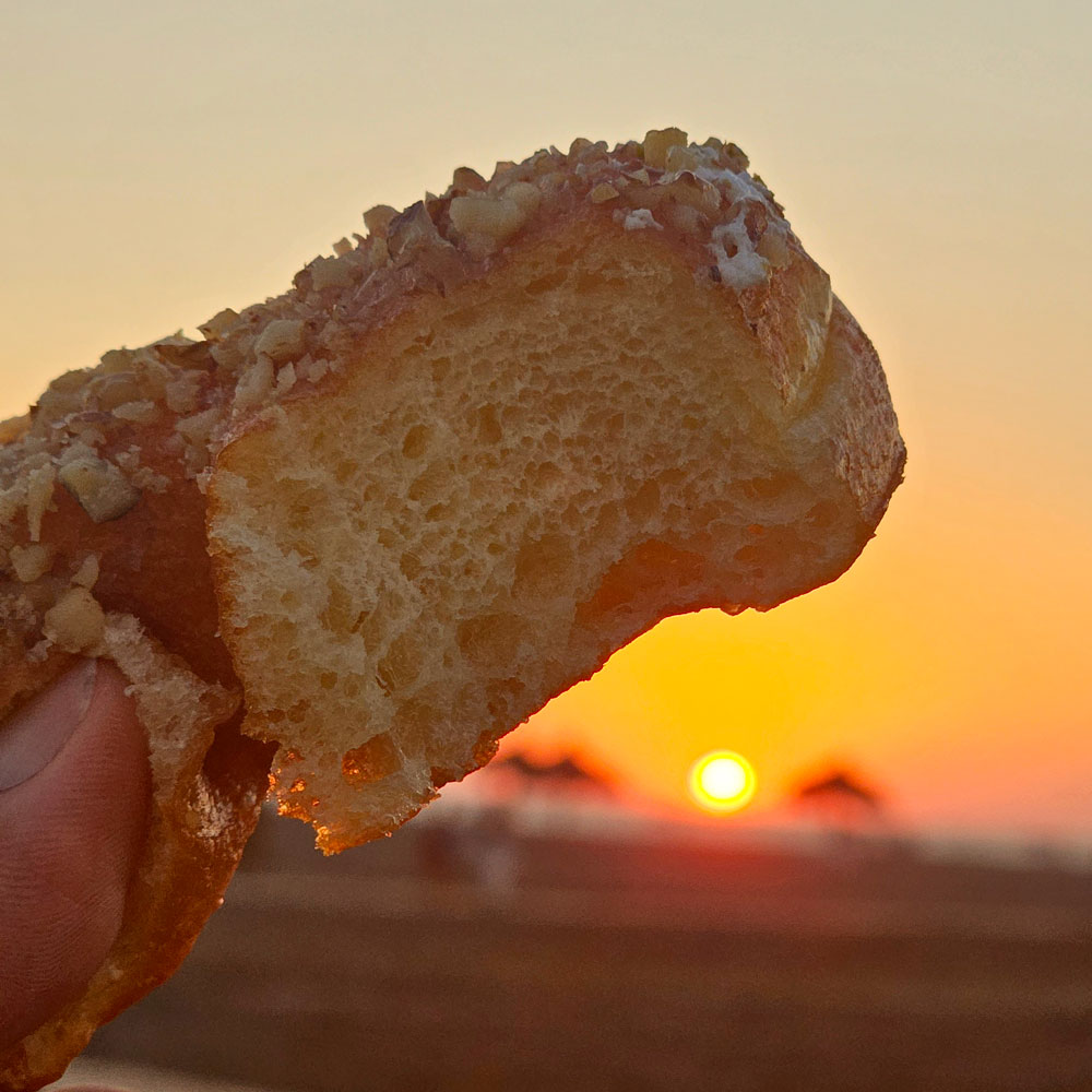 Honey walnut heart donut torn open at sunset